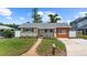 Charming single-story home featuring a landscaped front yard, updated siding, and a walkway to the front door at 840 Bethune Dr, Orlando, FL 32810