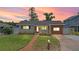 Charming single-story home featuring a landscaped front yard, updated siding, and a walkway to the front door at 840 Bethune Dr, Orlando, FL 32810