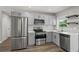 Updated kitchen boasts stainless steel appliances, gray cabinets and new countertops at 840 Bethune Dr, Orlando, FL 32810