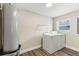 This practical laundry room includes a washer, dryer, and water heater to ensure convenience at 840 Bethune Dr, Orlando, FL 32810