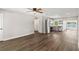 Open living space with hardwood floors leading to the kitchen area with stainless steel appliances at 840 Bethune Dr, Orlando, FL 32810