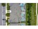 Aerial shot of rooftops overlooking several screened in pools, green lawns and a parking area at 850 Pebble Beach Dr, Davenport, FL 33896