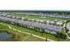 Beautiful aerial view of townhomes with screened in pools overlooking lush landscaping and a golf course community at 850 Pebble Beach Dr, Davenport, FL 33896
