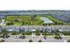 A community of new homes, with a central pond, lush vegetation, and ample parking at 850 Pebble Beach Dr, Davenport, FL 33896