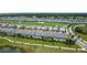 An aerial view displays townhomes with screened-in pools, beautifully integrated into a green golf course community at 850 Pebble Beach Dr, Davenport, FL 33896