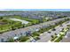 Expansive aerial view showcasing a well-planned community with modern townhomes, scenic ponds, and ample green spaces at 850 Pebble Beach Dr, Davenport, FL 33896