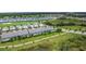 A picturesque aerial view of townhomes with screened-in pools nestled in a lush, green golf course community at 850 Pebble Beach Dr, Davenport, FL 33896