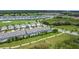 Aerial view of townhomes with screened-in pools overlooking a golf course, ponds, and surrounding neighborhoods at 850 Pebble Beach Dr, Davenport, FL 33896
