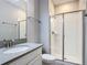 Modern bathroom featuring a sleek vanity, quartz countertop, and glass-enclosed shower at 850 Pebble Beach Dr, Davenport, FL 33896