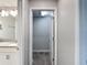 Bathroom features a single vanity, modern fixtures, and attached carpeted walk-in closet at 850 Pebble Beach Dr, Davenport, FL 33896