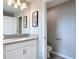 Modern bathroom featuring a sleek vanity with sink and adjacent toilet room at 850 Pebble Beach Dr, Davenport, FL 33896