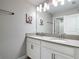 Bright bathroom with double vanity, large mirror, modern fixtures, and neutral finishes at 850 Pebble Beach Dr, Davenport, FL 33896