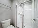 Clean bathroom features tile shower with glass door and modern toilet at 850 Pebble Beach Dr, Davenport, FL 33896