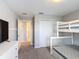 Inviting bedroom featuring a bunk bed, closet and connected bathroom at 850 Pebble Beach Dr, Davenport, FL 33896
