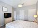 Neutral bedroom with TV and carpeted floors featuring multiple doorways and great light at 850 Pebble Beach Dr, Davenport, FL 33896