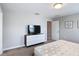 Bedroom featuring neutral walls, carpet, and TV on a modern dresser at 850 Pebble Beach Dr, Davenport, FL 33896