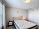 Comfortable bedroom features neutral colors, a plush mattress, and double door closet at 850 Pebble Beach Dr, Davenport, FL 33896