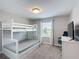 Cozy bedroom featuring bunk bed, desk and chair for comfortable sleeping and studying at 850 Pebble Beach Dr, Davenport, FL 33896