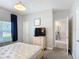 Bedroom featuring gray walls, carpet, and bedside tables with lamps at 850 Pebble Beach Dr, Davenport, FL 33896