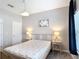 Bedroom featuring gray walls, carpet, and bedside tables with lamps at 850 Pebble Beach Dr, Davenport, FL 33896