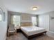 Neutral bedroom featuring carpeted floors, natural light, and stylish decor at 850 Pebble Beach Dr, Davenport, FL 33896