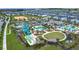 The community pool area includes a splash pad, water slides, and a playground; perfect for families at 850 Pebble Beach Dr, Davenport, FL 33896