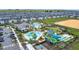 A fun community pool area featuring water slides, a splash pad, lounge chairs, and green spaces for recreation at 850 Pebble Beach Dr, Davenport, FL 33896