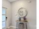 Inviting foyer featuring a decorative mirror and console table, showcasing a modern and stylish entryway at 850 Pebble Beach Dr, Davenport, FL 33896