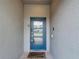 Close-up of a modern front door with glass panels, offering a glimpse into a welcoming home at 850 Pebble Beach Dr, Davenport, FL 33896