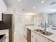 Open-concept kitchen with stainless appliances, quartz counters, and view to the living room at 850 Pebble Beach Dr, Davenport, FL 33896