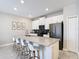 Modern kitchen featuring white cabinets, stainless steel appliances, and a large island with seating at 850 Pebble Beach Dr, Davenport, FL 33896