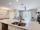 Bright kitchen island view of open floorplan to Gathering room and outdoor pool area at 850 Pebble Beach Dr, Davenport, FL 33896