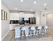 Contemporary kitchen with a large island, modern appliances, sleek cabinetry, and ample counter space at 850 Pebble Beach Dr, Davenport, FL 33896