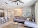 Spacious living area featuring a large sectional sofa, modern decor, and an open layout to the dining area at 850 Pebble Beach Dr, Davenport, FL 33896
