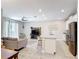 Open-concept living space with modern finishes, including a stylish kitchen island and comfortable seating area at 850 Pebble Beach Dr, Davenport, FL 33896