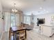 Open-concept living and dining area with stylish furniture, modern lighting, and seamless flow to kitchen at 850 Pebble Beach Dr, Davenport, FL 33896