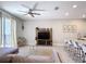 Living room featuring modern entertainment center and barstool seating at quartz countertop at 850 Pebble Beach Dr, Davenport, FL 33896