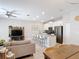 Living space flows into modern kitchen with island and features view of dining room at 850 Pebble Beach Dr, Davenport, FL 33896