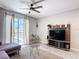 Stylish living room with sliding glass door leading to the pool area at 850 Pebble Beach Dr, Davenport, FL 33896