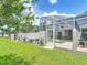 Manicured lawn with the privacy of a screened in pool, perfect for Gathering outdoor fun at 850 Pebble Beach Dr, Davenport, FL 33896