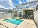 Backyard screened-in pool, offering the perfect retreat for relaxation and fun at 850 Pebble Beach Dr, Davenport, FL 33896