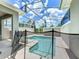 Outdoor screened-in pool with a safety fence offering relaxation and entertainment for Gathering and friends at 850 Pebble Beach Dr, Davenport, FL 33896