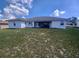 Expansive backyard featuring a covered patio and a well-maintained lawn at 8509 Sw 136Th Loop, Ocala, FL 34473