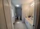 Functional bathroom with a vanity, tile flooring, and a shower-tub combination, providing a practical space at 8509 Sw 136Th Loop, Ocala, FL 34473