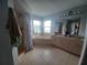 Bright bathroom featuring a large soaking tub, tiled floors, and a spacious vanity with dual sinks at 8509 Sw 136Th Loop, Ocala, FL 34473