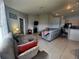 Comfortable living room with tile flooring and plenty of seating for relaxing and entertaining at 8509 Sw 136Th Loop, Ocala, FL 34473
