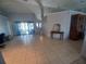 Spacious living room featuring tiled floors, bright natural lighting, and a seamless open-concept design at 8509 Sw 136Th Loop, Ocala, FL 34473