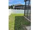 This backyard has a green lawn, a screen enclosure and a white vinyl fence at 9003 Pecky Cypress Way, Orlando, FL 32836