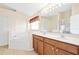 Bathroom featuring a double vanity, large soaking tub, and walk-in shower at 9003 Pecky Cypress Way, Orlando, FL 32836