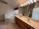 Well-lit bathroom with double sinks, a soaking tub, and a separate glass-enclosed shower at 9003 Pecky Cypress Way, Orlando, FL 32836